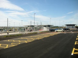 Looking across the car park to platforms A and B (left) and a staff building (right)
