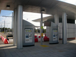 A couple of ticket machines and a display showing bus and tram departures at the end of the line
