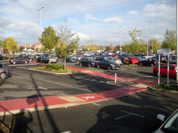 Looking across the car park towards the stop from one of the pedestrian entrances