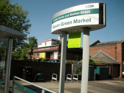 Stop name sign with compulsory ticket area sign hanging below